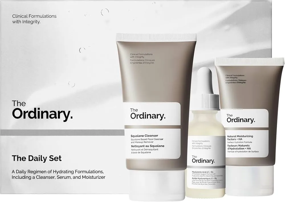 Five skincare sets lined up on a marble bathroom vanity counter.