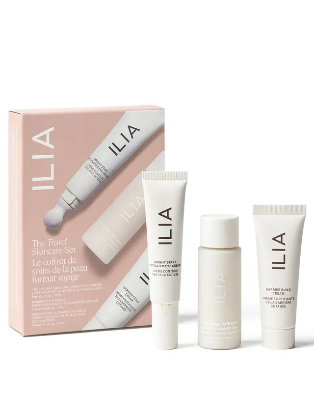 Skincare bottles sitting beside a marker pen on a pale bathroom shelf.
